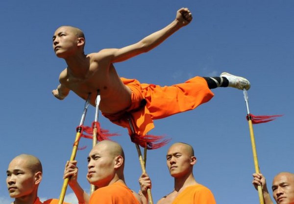 Shaolin Wu-Shu Warriors lift a colleague using spears during a photocall at the Chinese State Circus at Alexandra Palace in London