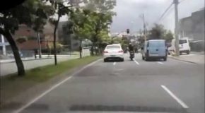 Idiot on Motorcycle Kicks Car, All Goes As Expected