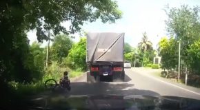 Bad Speed Bump Almost Sends Cyclist Under A Truck