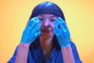 ASMR Video of A Woman Peeling Glittery Glue From Her Hands