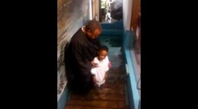 Kid Gets Too Excited While Getting Baptized, Does It Himself!