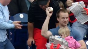 Fan Manages To Grab Foul Ball While Holding His Child!