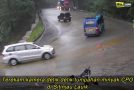 Vehicles Struggle To Drive Over A Steep Section Of The Road In The Rain