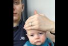 Man puts his baby to sleep by putting his hand over its face