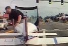 Police dashcam captures a plane making an emergency landing on a busy road