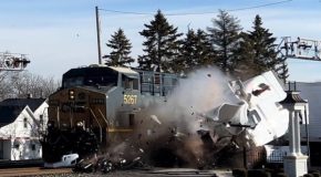 Semi-truck stuck on the path of a train gets smashed by a train
