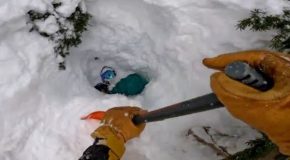 Snowboarder stuck under loose snow gets rescued by a stranger