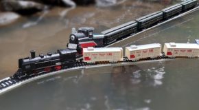 Model train rides over a body of water