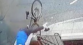 Cyclist going fast crashes and flips over a garden wall