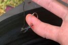 Man gets hooked through the finger while fishing and removes it like a champ