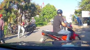 Scooter crashes and gets into a very close call between two cars