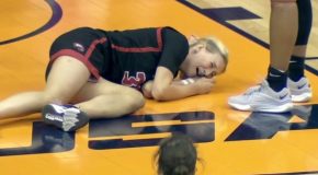 Swinging elbow by a basketball player causes the defender to lie flat on her back