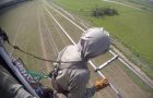Helicopter lineman fixes a line carrying 345,000 volts