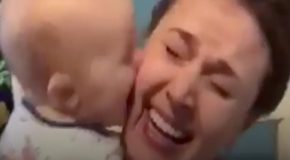 Mom gets covered in kisses by her 9-month-old baby