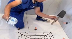 Young worker shows off his amazing tiling skills