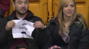 Man Placed Under The Kiss Cam Pulls Out A Funny Sign