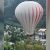 Crazy Hot Air Balloon Stunt Involves A Woman Being Pulled Up By It